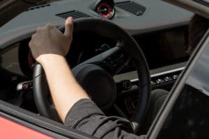 porsche-car-dashboard-porsche-car-steering-wheel-and-female-hand